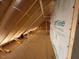 An unfinished attic with an exposed beam construction and insulation at 348 Inspiration Way, Fuquay Varina, NC 27526