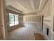 A bedroom with a tray ceiling and lots of natural light from a large window at 348 Inspiration Way, Fuquay Varina, NC 27526