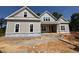 New two-story home featuring gray siding, double windows, and a covered porch with a stylish gable roofline at 348 Inspiration Way, Fuquay Varina, NC 27526