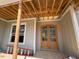 New construction with a beautiful glass panel front door and ladder in front of the window at 348 Inspiration Way, Fuquay Varina, NC 27526