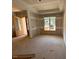 Living room featuring a beautiful door leading into the room and a large window offering abundant natural light at 348 Inspiration Way, Fuquay Varina, NC 27526