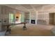 A spacious living room with fireplace and sliding glass doors leading to a deck with a view to the outside at 348 Inspiration Way, Fuquay Varina, NC 27526
