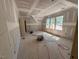 Sunlit room with three large windows, showcasing construction in progress at 348 Inspiration Way, Fuquay Varina, NC 27526