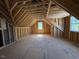Spacious attic with exposed wood beams, ready for customization and additional living space at 348 Inspiration Way, Fuquay Varina, NC 27526