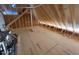 Spacious attic with wood beams and plywood flooring, offering potential for additional living space at 348 Inspiration Way, Fuquay Varina, NC 27526