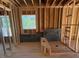 Unfinished bathroom with visible framing, shower stall, and a window for natural light at 348 Inspiration Way, Fuquay Varina, NC 27526