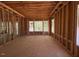 Unfinished bedroom with visible framing, large windows, and natural light creating an open atmosphere at 348 Inspiration Way, Fuquay Varina, NC 27526