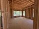Unfinished bedroom with visible framing, large windows, and natural light creating an open atmosphere at 348 Inspiration Way, Fuquay Varina, NC 27526