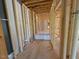 Partially framed hallway leading to a bathroom with a bathtub, ready for finishing touches at 348 Inspiration Way, Fuquay Varina, NC 27526