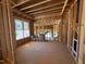 Unfinished Living Room with visible framing, large windows, and an open concept layout at 348 Inspiration Way, Fuquay Varina, NC 27526