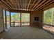 A screened-in back porch with rustic walls and outdoor views to the nature behind the home at 348 Inspiration Way, Fuquay Varina, NC 27526