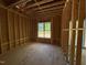 Partially framed room with a window providing natural light, ready for customization at 348 Inspiration Way, Fuquay Varina, NC 27526