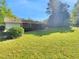 Home featuring a lush, green backyard on a sunny day at 3504 Crofton Ct, Raleigh, NC 27604