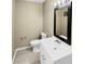 Well-lit half-bathroom with a modern vanity, toilet, and stylish accents at 3504 Crofton Ct, Raleigh, NC 27604