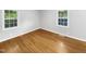 Bright bedroom with hardwood floors and white trim windows allowing natural light to fill the space at 3504 Crofton Ct, Raleigh, NC 27604