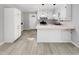 Bright kitchen with white cabinets, sleek countertops, and modern pendant lighting above the breakfast bar at 3504 Crofton Ct, Raleigh, NC 27604