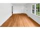 An empty living room showcasing gleaming hardwood floors and plenty of natural light at 3504 Crofton Ct, Raleigh, NC 27604