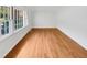 Bright living room featuring hardwood flooring, large windows, and ample natural light at 3504 Crofton Ct, Raleigh, NC 27604