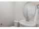 Clean half bathroom with modern fixtures and a stylish vanity mirror at 3715 Rosebush Dr, Zebulon, NC 27597