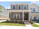 Charming two-story home featuring a welcoming front porch with stylish brick accents and manicured landscaping at 3715 Rosebush Dr, Zebulon, NC 27597