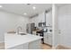 Modern kitchen with stainless steel appliances, sleek countertops, and stylish white cabinetry at 3715 Rosebush Dr, Zebulon, NC 27597