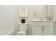 Clean bathroom featuring a white vanity, matching toilet, and shower combo at 4008 Shadbush St, Raleigh, NC 27616