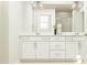 Elegant bathroom with double sink vanity, modern fixtures, white cabinetry, and a glass enclosed shower at 4008 Shadbush St, Raleigh, NC 27616