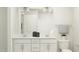 Bright bathroom featuring a double sink vanity with white cabinets and a large mirror at 4008 Shadbush St, Raleigh, NC 27616