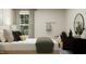 Bedroom with a large window, bed, and desk; decorated with earth tones at 4008 Shadbush St, Raleigh, NC 27616