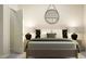 Cozy bedroom featuring a bed with decorative pillows, lamps, and a round mirror at 4008 Shadbush St, Raleigh, NC 27616
