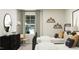 Modern bedroom featuring twin beds, a dark dresser, and a neutral color scheme at 4008 Shadbush St, Raleigh, NC 27616