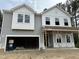 New two-story home showing gray siding, white trim, and an attached two-car garage at 4008 Shadbush St, Raleigh, NC 27616