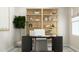 Bright home office featuring a desk, a light wood bookcase, stylish decor, and a window with natural light at 4008 Shadbush St, Raleigh, NC 27616
