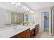 Bright bathroom featuring double vanity sinks, large mirror and separate shower at 402 Vatersay Dr, Apex, NC 27502