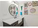 Bathroom vanity with a white countertop, farmhouse sink, black fixtures, and framed artwork at 402 Vatersay Dr, Apex, NC 27502