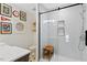 Charming bathroom with shower featuring subway tile and glass door, with playful decor at 402 Vatersay Dr, Apex, NC 27502