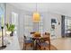 Sunlit dining area with a round table, seating, and a view of the backyard creates an inviting space for meals at 402 Vatersay Dr, Apex, NC 27502