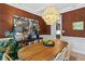 Well-lit dining room featuring an oversized pendant light fixture and natural-themed statement wall art at 402 Vatersay Dr, Apex, NC 27502