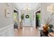 Bright and airy foyer with hardwood floors, decorative lighting, and views to the front door at 402 Vatersay Dr, Apex, NC 27502