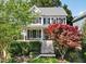 Charming two-story home with a welcoming front porch and beautifully landscaped front yard at 402 Vatersay Dr, Apex, NC 27502