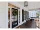 Inviting covered front porch with a wreath-adorned door and comfortable seating area at 402 Vatersay Dr, Apex, NC 27502