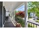 Spacious covered front porch with classic columns, black shutters, and comfortable outdoor seating at 402 Vatersay Dr, Apex, NC 27502