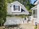 White two car garage with an upstairs window and climbing plants at 402 Vatersay Dr, Apex, NC 27502