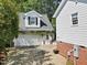 Two-car garage features white exterior and climbing plants, adding charm to the home at 402 Vatersay Dr, Apex, NC 27502
