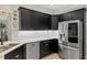 Chic kitchen featuring stainless steel appliances, black cabinetry, and white countertops at 402 Vatersay Dr, Apex, NC 27502