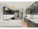 Modern kitchen with black cabinets, stainless steel appliances, quartz countertops, and a subway tile backsplash at 402 Vatersay Dr, Apex, NC 27502