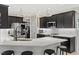 Elegant kitchen boasts black cabinets, stainless steel appliances, a peninsula, and a sleek design at 402 Vatersay Dr, Apex, NC 27502