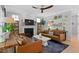 Cozy living room features a fireplace, comfortable sofas, and plenty of natural light from the windows at 402 Vatersay Dr, Apex, NC 27502