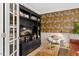 Cozy living room with dark bookcase, zebra wallpaper, and modern armchair near french doors at 402 Vatersay Dr, Apex, NC 27502