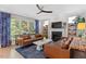 Stylish living room with a fireplace, and comfortable leather sofas, creating a relaxing atmosphere at 402 Vatersay Dr, Apex, NC 27502